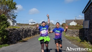 Pictured are Andrew Fahey and Jeff Lau crossing the finish line at last year's Aer Arann Islands Half Marathon on Inis M&oacute;r. Registrations are under way for the 2026 event, supporting patients in the Mater Public Hospital. To get your ticket, visit www.materfoundation.ie/aerarann