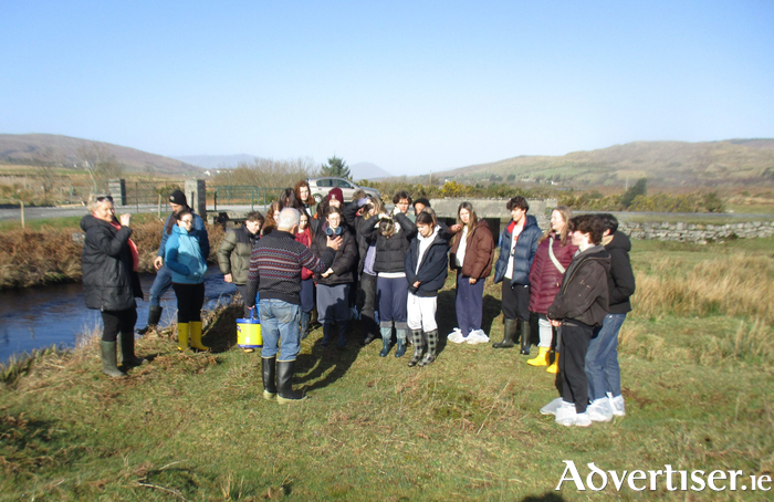 Group of students on the river bank.