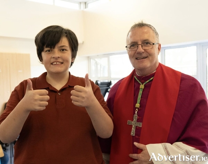 Bishop Michael Duignan pictured with a student from &Aacute;balta Special School celebrating receipt of their Communion and Confirmation sacraments with their families.