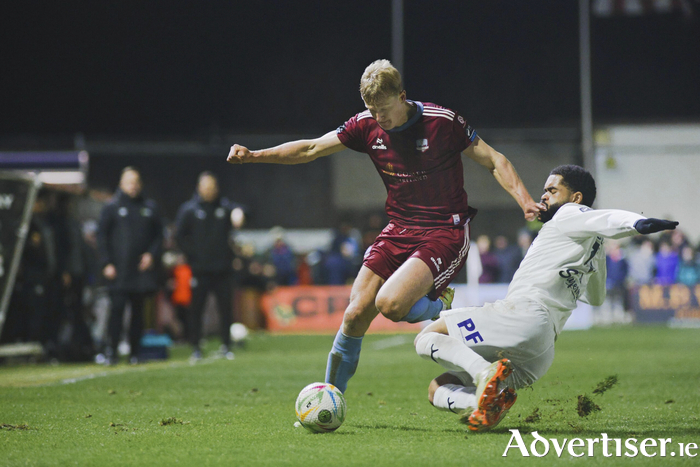 Galway United's Kristopher Twardek who bagged two goals against Waterford FC is tackled by Trae Coyle in the SSE Airtricity Men's Premier Division game at Eamonn Deacy Park on Monday night. (Photo: Mike Shaughnessy)