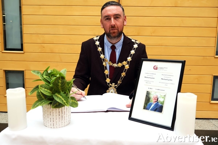 Mayor Cubbard signing the Book of Condolence at City Hall for Michael Lyster.