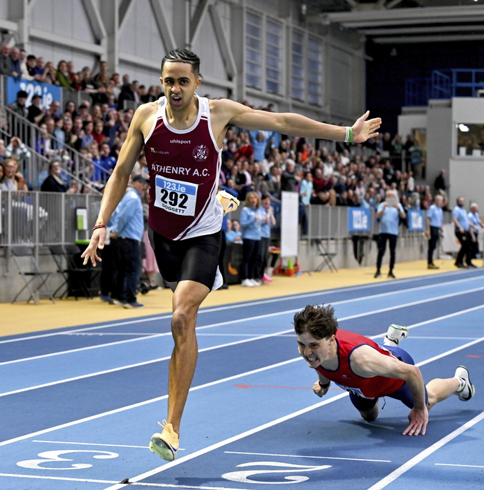 Sean Doggett of Athenry AC, Galway, left, on his way to winning the men's 400m as Fintan Dewhirst of T&iacute;r Chonaill AC, Donegal, falls during day two of the 123.ie National Senior Indoor Championships at the National Indoor Arena on the Sport Ireland Campus in Dublin. (Photo by Sam Barnes/Sportsfile)