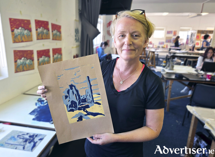 Art student Rachel Lillis preparing for the upcoming exhibition.