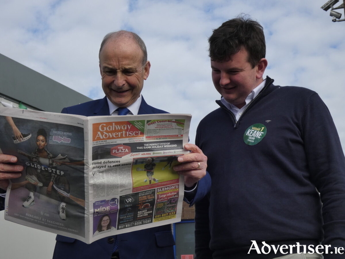 Taoiseach Miche&aacute;l Martin with Fianna F&aacute;il by-election hopeful, Councillor Cillian Keane, hoovering up political info