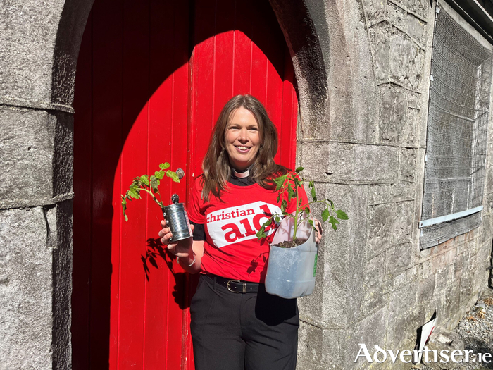 Provost Rev Lynda Peilow, pictured with vegetables growing in a milk container and tin can.