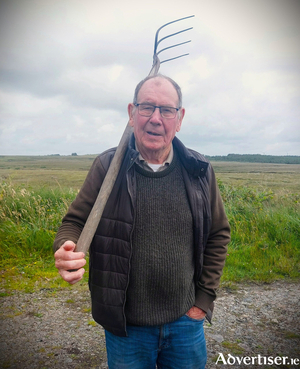 Cllr Tom&aacute;s &Oacute; Curraoin with pitchfork in hand
