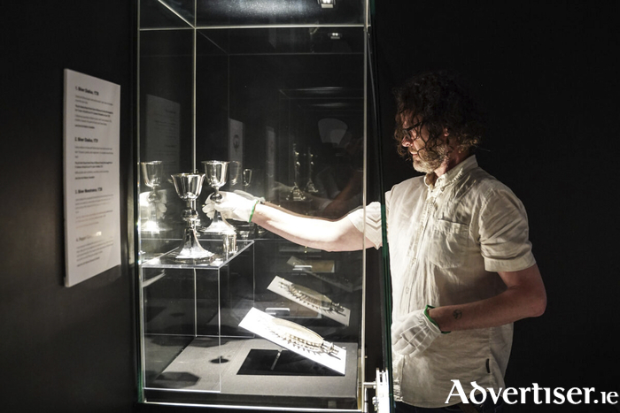James Reynolds, museum technician placing the chalices in the Silver Room at Galway City Museum.