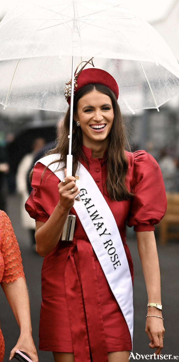 Jodie pictured sheltering from the showers at Galway Races.
