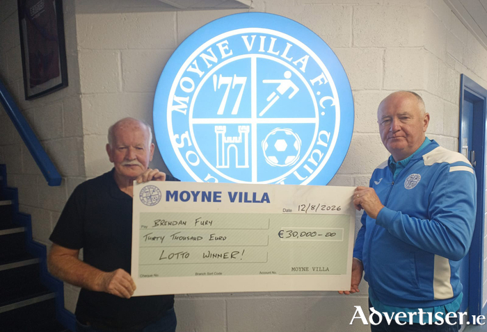 Moyne Villa lotto winner Brendan Fury (left) pictured accepting his &euro;30,000 jackpot winnings from club treasurer Tom Walsh.