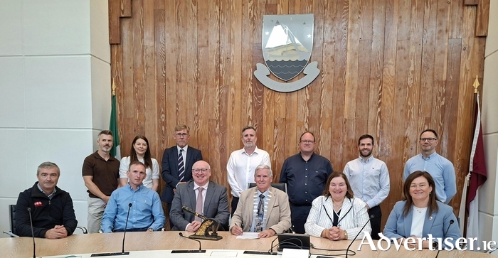 Pictured at &Aacute;ras an Chontae for the signing of the &euro;15.1 million contract for the construction of a new social housing development in Tuam. Front row, left to right: Damien O&rsquo;Brien, Contracts Manager, OCC; Peter O&rsquo;Connell, Managing Director, OCC; Liam Conneally, Chief Executive; Michael Regan, Leas Cathaoirleach; Mary Hoade, Tuam Municipal District Cathaoirleach; and Liadhan Keady, Corporate Services. Back row, left to right: Kieran Keon, Acting Housing Director (Senior Social Worker); Ciara McDonagh, Executive Architect; Uinsinn Finn, Director of Services; Alan Brogan, Senior Executive Engineer; Donagh Mark Killilea, Municipal District Leas Cathaoirleach; Damien Redington, Senior Engineer; and Kevin Gavin, Assistant Engineer. 
Credit Galway County Council. 