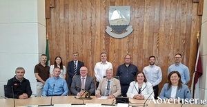 Pictured at &Aacute;ras an Chontae for the signing of the &euro;15.1 million contract for the construction of a new social housing development in Tuam. Front row, left to right: Damien O&rsquo;Brien, Contracts Manager, OCC; Peter O&rsquo;Connell, Managing Director, OCC; Liam Conneally, Chief Executive; Michael Regan, Leas Cathaoirleach; Mary Hoade, Tuam Municipal District Cathaoirleach; and Liadhan Keady, Corporate Services. Back row, left to right: Kieran Keon, Acting Housing Director (Senior Social Worker); Ciara McDonagh, Executive Architect; Uinsinn Finn, Director of Services; Alan Brogan, Senior Executive Engineer; Donagh Mark Killilea, Municipal District Leas Cathaoirleach; Damien Redington, Senior Engineer; and Kevin Gavin, Assistant Engineer. 
Credit Galway County Council. 
