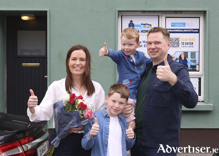 Jacqueline O&rsquo;Gorman outside the home she won in last Monday&rsquo;s Oranmore Maree GAA One Club Win A Home draw. Also in the picture is her husband Richard Kiely and children Sam and George. 
