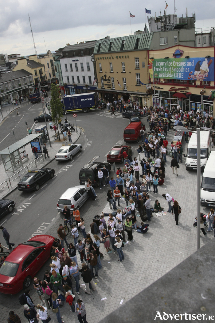 There was a time when finding out you had secured a college place in Galway came with another, equally important rite of passage: finding somewhere to live.
For almost three decades, in the weeks after students discovered they were coming to Galway, there was one ritual that told the city the students were on their way.
In those days, accommodation was considerably more plentiful than it is now, and much of it was advertised in the Galway Advertiser. On the day before publication, we would print the accommodation pages and sell them for &pound;1, with the proceeds donated to local charities.
Up to 1,000 students could queue outside the Advertiser offices from dawn, desperate to be among the first to get their hands on the listings. This was long before mobile phones, of course. Once they had their precious pages, they would dash to one of the phone kiosks around the Square and start making calls, trying to secure a viewing before somebody else got there first.
It was a wonderfully chaotic ritual, but it was also a reminder of something important: the students were coming back.
The accommodation pages eventually disappeared, made redundant by the internet and online classified advertising. They belonged to their time, but for roughly 30 years they were part of the fabric of Galway.
One year, an enterprising young lad at the front of the queue took his copy to a photocopier, produced a few hundred duplicates, returned to the back of the queue and started selling them for a fiver.
I often wonder what happened to him. He is probably a millionaire today &mdash; or in jail.
Those accommodation pages did more than raise money for local charities. They announced the annual arrival of thousands of young people who would bring colour, energy, noise, ideas and money into the city.
Galway is fortunate to have a student population approaching 30,000. That is an enormous part of the city&rsquo;s demographic and identity. Many students will eventually leave, but almost everyone leaves something of themselves behind.
That is why it is heartbreaking to see the traditional student experience becoming increasingly difficult to access.
Student representatives are now calling for urgent action as the new academic year begins. A sleep-out was this week held in the city to highlight the shortage, while student unions warn that some students face hours-long commutes or may even have to defer their college places because they cannot find somewhere affordable to live.
There are new purpose-built student accommodation developments, but student representatives argue that much of this is simply too expensive for ordinary students and has done little to solve the wider crisis.
At the same time, short-term rental accommodation continues to remove homes from the long-term market. Around 100 houses and apartments are currently listed on Airbnb around Galway city, while rooms advertised on Daft start at about &euro;750 a month.
That is not merely an accommodation problem. It is an education problem, a social problem and, ultimately, a problem for Galway itself.
Forty-one years ago this week, I arrived in Galway as a student. It changed my life and formed the basis of a book (Kittyland) which detailed the reality of living away from home for the first and perhaps most formative time.
Living here, rather than simply travelling here for lectures, was a huge part of that experience. The friendships, the independence, the baked beans, the late nights, the accidental encounters, the music, the pubs, the streets and the sheer sense of being somewhere new all shaped the person I became.
Going to college is supposed to offer young people an opportunity to reinvent themselves. At 18, you arrive somewhere where nobody knows who you were at school. You can make new friends, discover new interests and become a slightly different version of yourself.
But that becomes much harder when your college experience consists of getting up at dawn, travelling for hours to attend lectures and then heading straight home again.
Students were always destined to leave Galway eventually. The tragedy would be if we start making it impossible for them to properly arrive in the first place.
The accommodation pages may be gone. The phone kiosks have disappeared. The &pound;1 listings are a memory.
But the rite of passage they represented should not disappear with them.
Galway needs its students. More importantly, its students need Galway.
